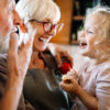 Happy grandparents playing with their little cute granddaughter